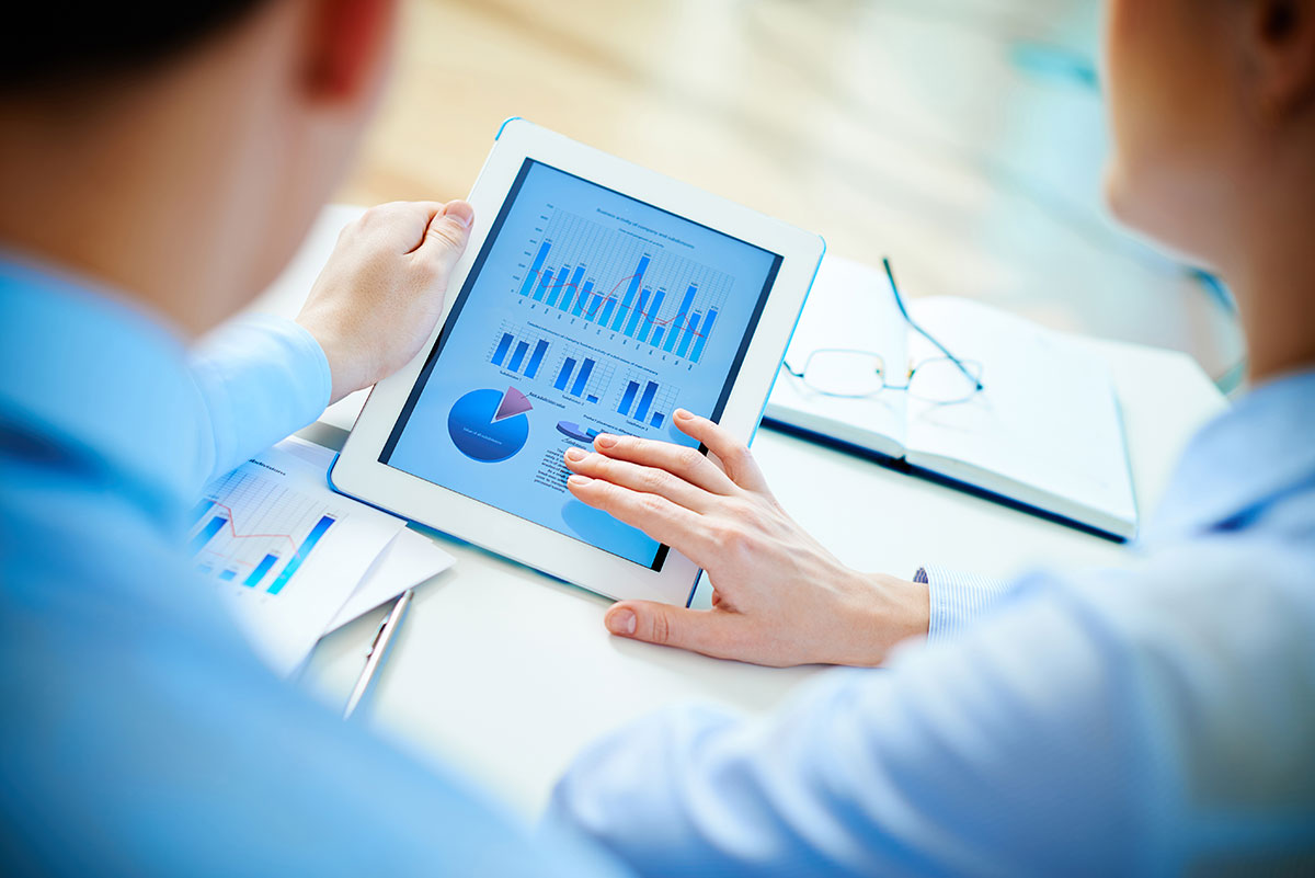 Executives checking diagrams with touchpad